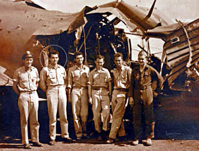 Tommy Rybovich (circled) with crew and battered B-17