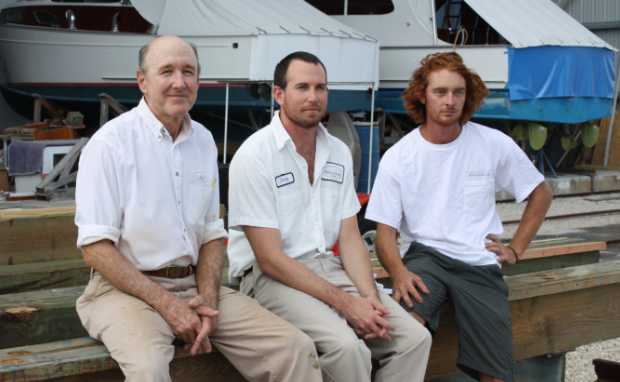 L-R: Michael, Dusty, and Alex seated in the boatyard